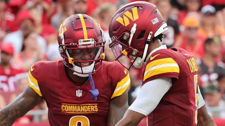 Sep 8, 2024; Tampa, Florida, USA;  Washington Commanders quarterback Jayden Daniels (5) celebrates with wide receiver Dyami Brown (2) after he scored a touchdown during the second half at Raymond James Stadium. Mandatory Credit: Kim Klement Neitzel-Imagn Images