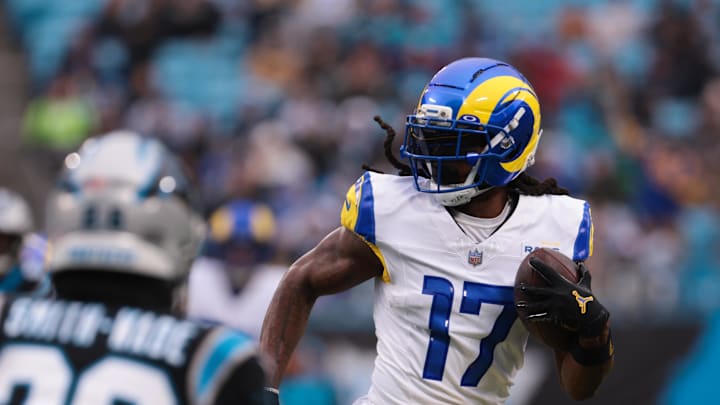 Nov 30, 2025; Charlotte, North Carolina, USA; Los Angeles Rams wide receiver Davante Adams (17) runs after making a catch as Carolina Panthers cornerback Chau Smith-Wade (26) defends during the first quarter at Bank of America Stadium. Mandatory Credit: Scott Kinser-Imagn Images