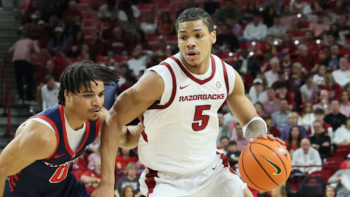 Arkansas Razorbacks guard Darius Acuff Jr (5) drives against Samford Bulldogs guard Isaiah Campbell-Finch (0) during the second half at Bud Walton Arena. Arkansas won 79-75.