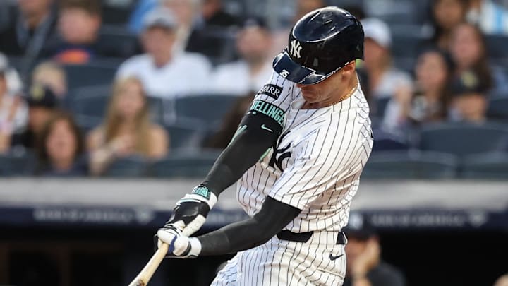 Aug 25, 2025; Bronx, New York, USA;  New York Yankees right fielder Cody Bellinger (35) hits a run scoring sacrifice fly in the first inning against the Washington Nationals at Yankee Stadium.