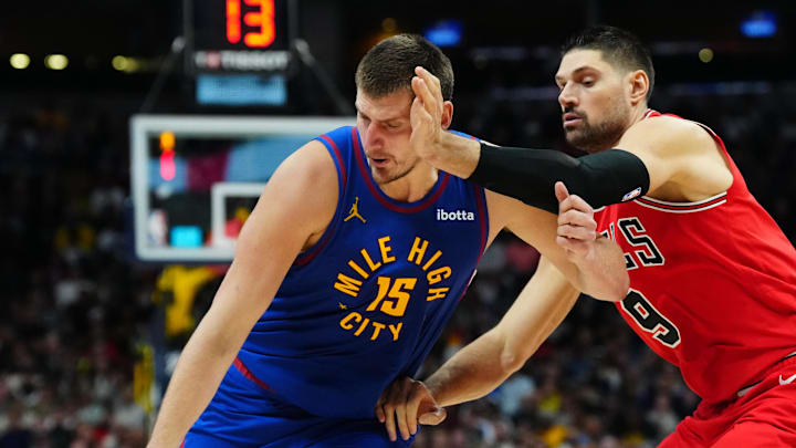 Nov 4, 2023; Denver, Colorado, USA; Denver Nuggets center Nikola Jokic (15) drives past Chicago Bulls center Nikola Vucevic (9) in the second half at Ball Arena.