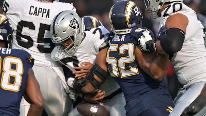 Nov 30, 2025; Inglewood, California, USA; Las Vegas Raiders quarterback Geno Smith (7) fumbles the ball against the Los Angeles Chargers during the first half at SoFi Stadium. Mandatory Credit: Jayne Kamin-Oncea-Imagn Images