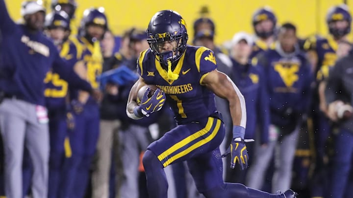 Nov 23, 2024; Morgantown, West Virginia, USA; West Virginia Mountaineers running back Jahiem White (1) runs the ball against the UCF Knights during the third quarter at Mountaineer Field at Milan Puskar Stadium. Mandatory Credit: Ben Queen-Imagn Images