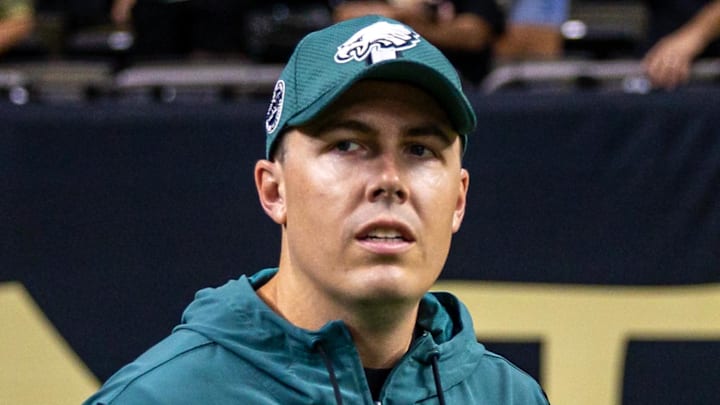 Sep 22, 2024; New Orleans, Louisiana, USA; Philadelphia Eagles offensive coordinator Kellen Moore looks on during warmups before the game against the New Orleans Saints at Caesars Superdome. Mandatory Credit: Stephen Lew-Imagn Images
