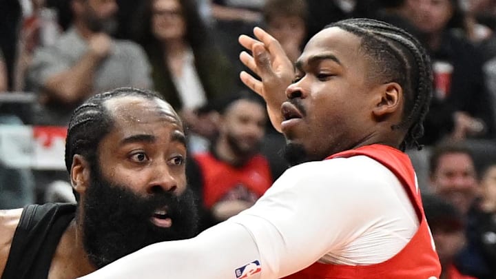 Cleveland Cavaliers guard James Harden looks for a passing option as he is covered by Toronto Raptors guard Jamal Shead.