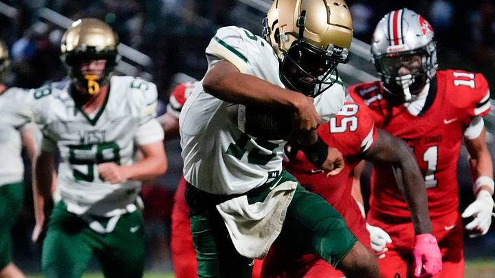Iowa City West’s Reece Wheeler (15) hurdles a City High player during a week 1 Iowa high school football game Aug. 29, 2025 at Iowa City City High in Iowa City, Iowa. Iowa City West’s Reece Wheeler (15) hurdles a City High player during a week 1 Iowa high school football game Aug. 29, 2025 at Iowa City City High in Iowa City, Iowa.