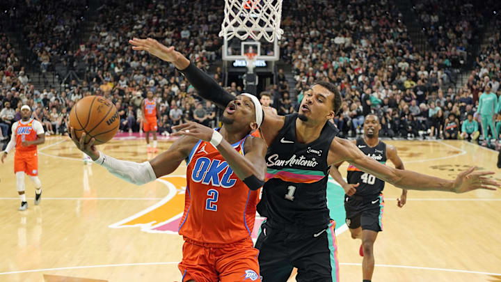 Dec 23, 2025; San Antonio, Texas, USA; Oklahoma City Thunder guard Shai Gilgeous-Alexander (2) drives to the basket past San Antonio Spurs forward Victor Wembanyama (1) during the first half at Frost Bank Center. Mandatory Credit: Scott Wachter-Imagn Images Dec 23, 2025; San Antonio, Texas, USA; Oklahoma City Thunder guard Shai Gilgeous-Alexander (2) drives to the basket past San Antonio Spurs forward Victor Wembanyama (1) during the first half at Frost Bank Center. Mandatory Credit: Scott Wachter-Imagn Images