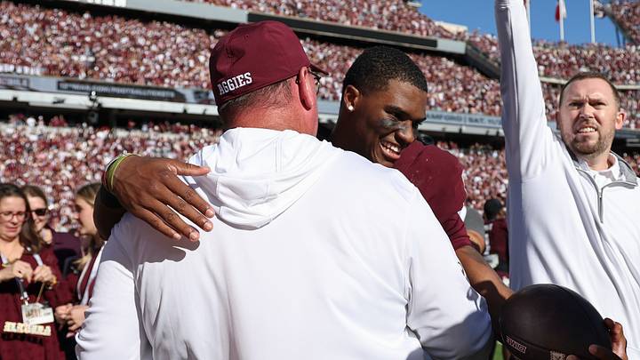 Texas A&M Aggies quarterback Marcel Reed (10) embraces head coach Mike Elko after the game against the South Carolina Gamecocks at Kyle Field. Texas A&M Aggies quarterback Marcel Reed (10) embraces head coach Mike Elko after the game against the South Carolina Gamecocks at Kyle Field.