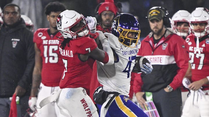 Dec 28, 2024; Annapolis, MD, USA; East Carolina Pirates running back Rahjai Harris (47) stiff arms North Carolina State Wolfpack safety Bishop Fitzgerald (7) during the second half of the Go Bowling Military Bowl at Navy-Marine Corps Memorial Stadium. Mandatory Credit: Tommy Gilligan-Imagn Images Dec 28, 2024; Annapolis, MD, USA; East Carolina Pirates running back Rahjai Harris (47) stiff arms North Carolina State Wolfpack safety Bishop Fitzgerald (7) during the second half of the Go Bowling Military Bowl at Navy-Marine Corps Memorial Stadium. Mandatory Credit: Tommy Gilligan-Imagn Images