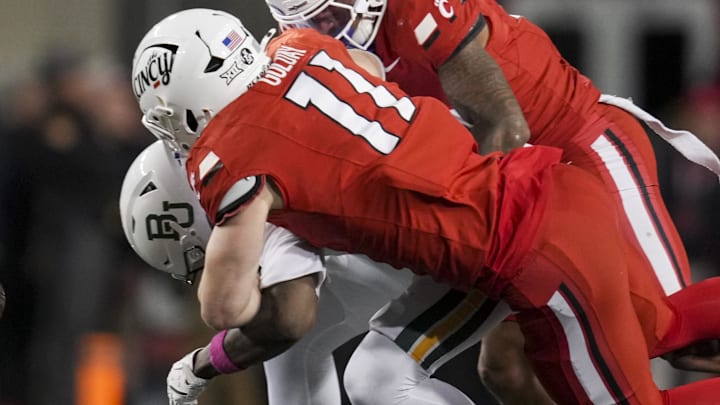Oct 25, 2025; Cincinnati, Ohio, USA;  Baylor Bears tight end Michael Trigg (1) is unable to hold on to a catch as he is tackled by Cincinnati Bearcats linebacker Jake Golday (11) and defensive back Tre Gola-Callard (6) in the second half at Nippert Stadium. 