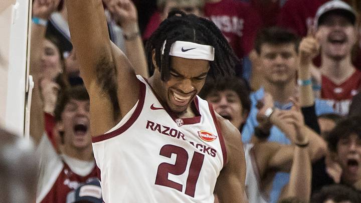 Oct 24, 2026; Fayetteville, AK, USA;  Arkansas Razorbacks forward Cooper Bowser (21) hands onto the rim after a dunk during the second half against the Gonzaga Bulldogs at Bud Walton Arena.  Mandatory Credit: Brett Rojo-Imagn Images
