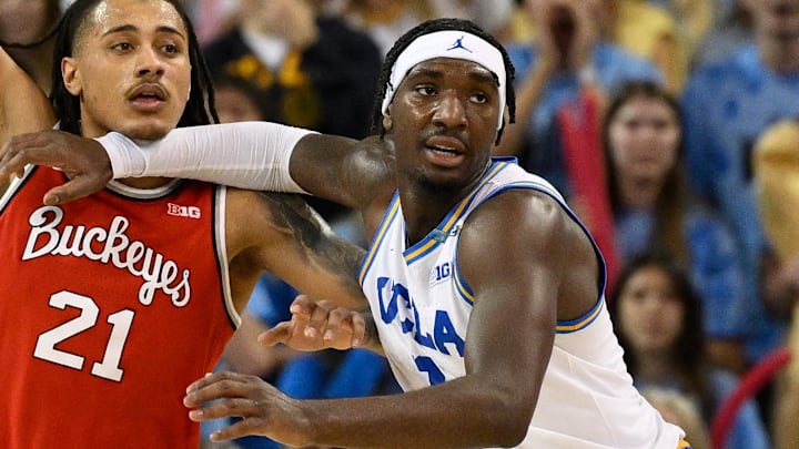 Feb 23, 2025; Los Angeles, California, USA; Ohio State Buckeyes forward Devin Royal (21) and UCLA Bruins guard Eric Dailey Jr. (3) jockey for position during the second half  at Pauley Pavilion presented by Wescom. Mandatory Credit: Robert Hanashiro-Imagn Images