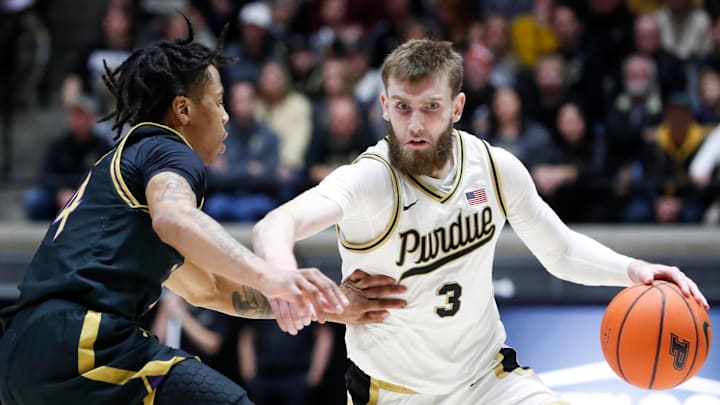 Northwestern Wildcats guard K.J. Windham (24) defends Purdue Boilermakers guard Braden Smith (3) 
