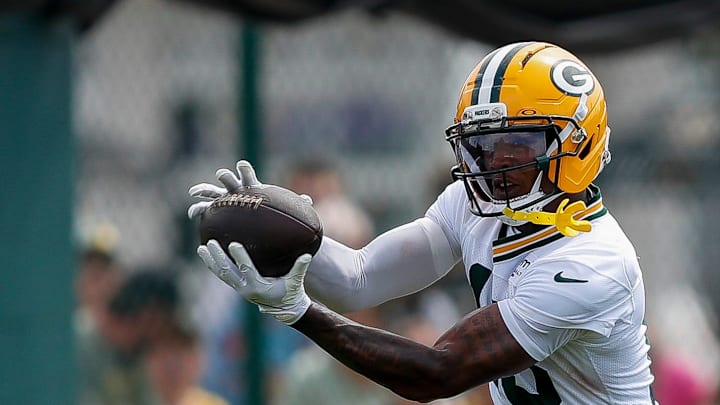 Green Bay Packers wide receiver Dontayvion Wicks (13) catches a pass during the first day of training camp on Wednesday.