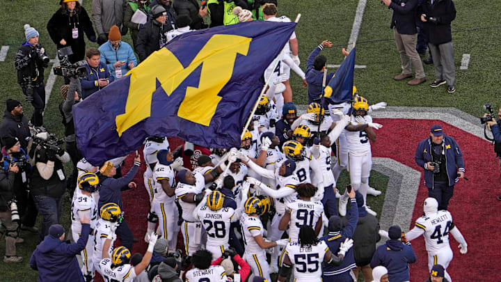 Michigan football players plant their team’s flag at midfield following Saturday’s game against the Ohio State Buckeyes at Ohio Stadium. The Wolverines won the game, 13-10. Michigan football players plant their team’s flag at midfield following Saturday’s game against the Ohio State Buckeyes at Ohio Stadium. The Wolverines won the game, 13-10.