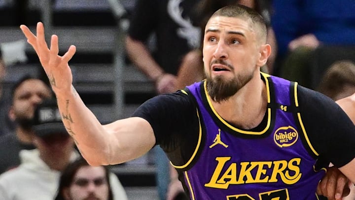 Former Los Angeles Lakers center Alex Len (27) reaches for the ball against Milwaukee Bucks center Jericho Sims (00) in the second quarter at Fiserv Forum.