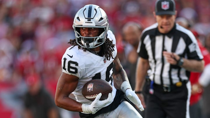Dec 8, 2024; Tampa, Florida, USA; Las Vegas Raiders wide receiver Jakobi Meyers (16) runs with the ball against the Tampa Bay Buccaneers in the fourth quarter at Raymond James Stadium. Mandatory Credit: Nathan Ray Seebeck-Imagn Images