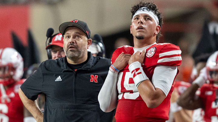 Nebraska head coach Matt Rhule and quarterback Dyaln Raiola look up at the scoreboard during the second quarter against Illinois.