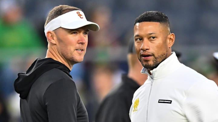 Oct 14, 2023; South Bend, Indiana, USA; USC Trojans head coach Lincoln Riley and Notre Dame Fighting Irish head coach Marcus Freeman chat before the game at Notre Dame Stadium. 