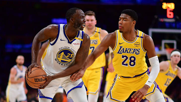 Apr 3, 2025; Los Angeles, California, USA; Golden State Warriors forward Draymond Green (23) controls the ball against Los Angeles Lakers forward Rui Hachimura (28) during the second half at Crypto.com Arena. Mandatory Credit: Gary A. Vasquez-Imagn Images