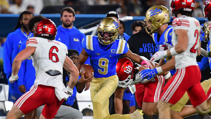 Aug 30, 2025; Pasadena, California, USA; UCLA Bruins quarterback Nico Iamaleava (9) runs the ball against Utah Utes safety Nate Ritchie (6) during the first half at Rose Bowl. Mandatory Credit: Gary A. Vasquez-Imagn Images
