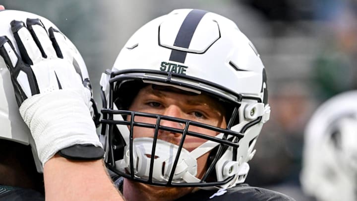 Michigan State's Matt Gulbin, right, hugs quarterback Aidan Chiles before the football game against Boston College on Saturday, Sept. 6, 2025, at Spartan Stadium in East Lansing.