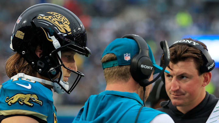 Jacksonville Jaguars quarterback Trevor Lawrence (16) looks on as head coach Liam Coen talks a play with offensive coordinator Grant Udinski looking on during the first quarter of an NFL football game at EverBank Stadium, Sunday, Dec. 7, 2025, in Jacksonville, Fla. The Jaguars defeated the Colts 36-19.