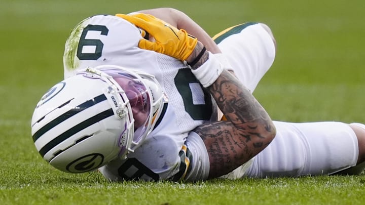 Green Bay Packers receiver Christian Watson lies on the field following an injury during the third quarter at the Broncos.