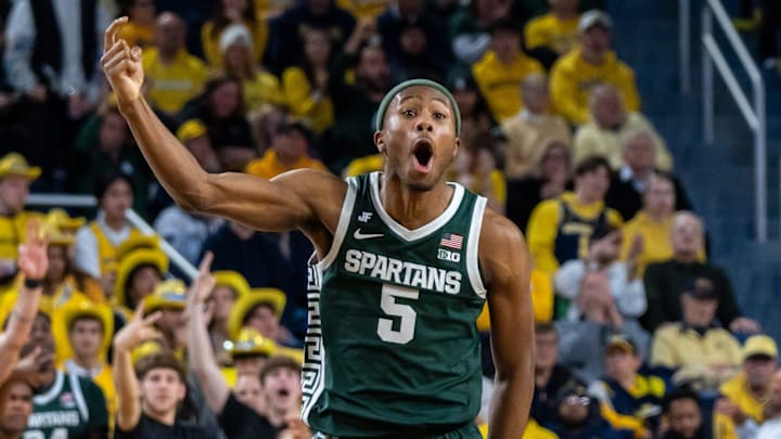 Michigan State’s Tre Holloman (5) celebrates after his team scores a basket against Michigan’s defense during the second half of their matchup at Crisler Center in Ann Arbor on Friday, Feb. 21, 2025.