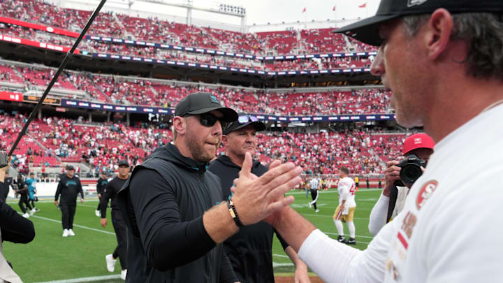 Sep 28, 2025; Santa Clara, California, USA; Jacksonville Jaguars head coach Liam Coen (center) shakes hands with San Francisco 49ers head coach Kyle Shanahan (right) after the game at Levi's Stadium. Mandatory Credit: Darren Yamashita-Imagn Images