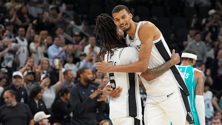 Mar 14, 2026; San Antonio, Texas, USA; San Antonio Spurs forward Victor Wembanyama (1) hugs guard Stephon Castle (5) after the game against the Charlotte Hornets at Frost Bank Center.