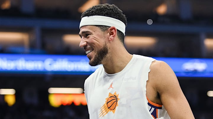 Nov 26, 2025; Sacramento, California, USA; Phoenix Suns guard Devin Booker (1) smiles on the sideline during the second quarter of the game against the Sacramento Kings at Golden 1 Center. Mandatory Credit: Ed Szczepanski-Imagn Images