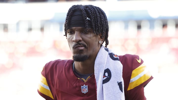 Oct 20, 2024; Landover, Maryland, USA; Washington Commanders quarterback Jayden Daniels (5) walks off the field during the first quarter after an injury against the Carolina Panthers at Northwest Stadium. Mandatory Credit: Amber Searls-Imagn Images