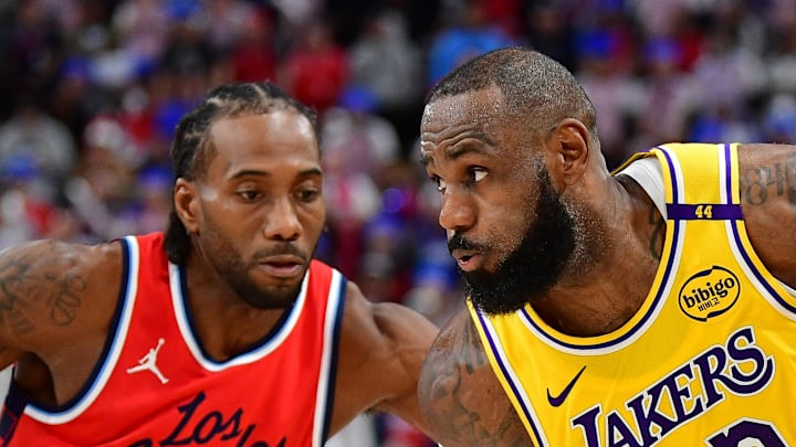 Feb 4, 2025; Inglewood, California, USA; Los Angeles Lakers forward LeBron James (23) moves the ball against Los Angeles Clippers forward Kawhi Leonard (2) during the second half at Intuit Dome. Mandatory Credit: Gary A. Vasquez-Imagn Images