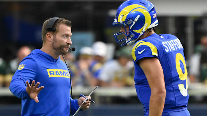 Oct 6, 2024; Inglewood, California, USA; Los Angeles Rams head coach Sean McVay talks to quarterback Matthew Stafford (9) during the third quarter against the Green Bay Packers at SoFi Stadium. Mandatory Credit: Robert Hanashiro-Imagn Images