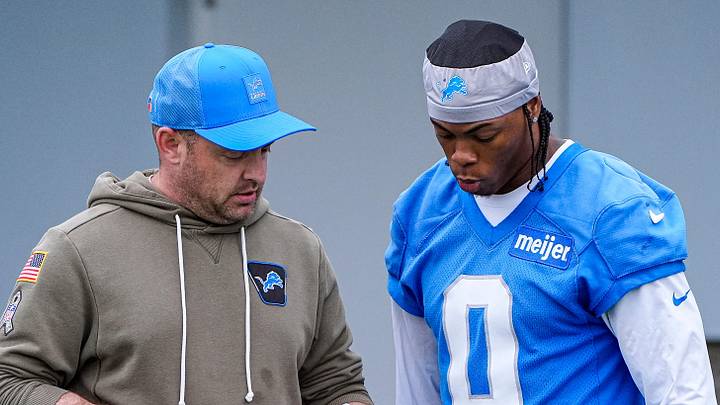 Detroit Lions offensive coordinator Drew Petzing, left, talks to running back Jahmyr Gibbs (0) before OTAs at Meijer Performance Center in Allen Park on Thursday, June 11, 2026.