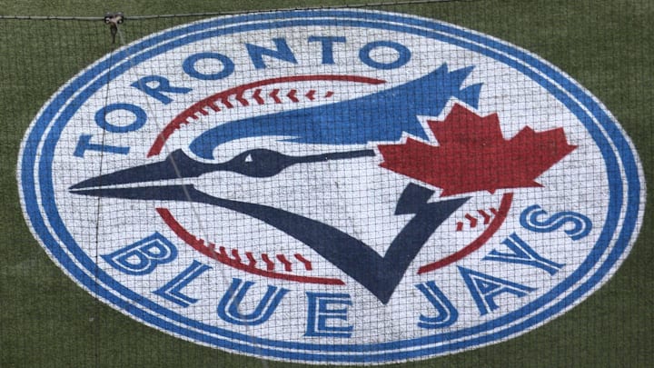 The Toronto Blue Jays logo embedded on the turf behind home plate. 