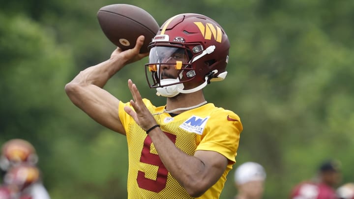 Jun 5, 2024; Ashburn, VA, USA; Washington Commanders quarterback Jayden Daniels (5) passes a ball during an OTA workout at Commanders Park. Mandatory Credit: Geoff Burke-USA TODAY Sports