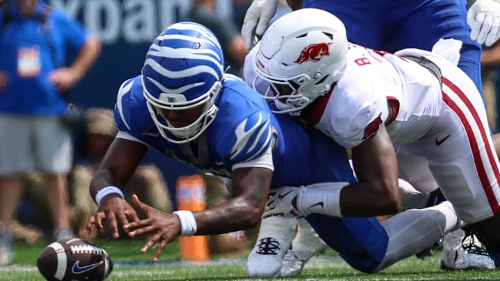 Memphis Tigers quarterback Brendon Lewis (2) and Arkansas Razorbacks linebacker Bradley Shaw (7) dive for a loose ball during the second half at Simmons Bank Liberty Stadium in Memphis, Tenn. Memphis Tigers quarterback Brendon Lewis (2) and Arkansas Razorbacks linebacker Bradley Shaw (7) dive for a loose ball during the second half at Simmons Bank Liberty Stadium in Memphis, Tenn.