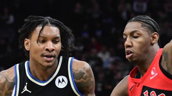 Milwaukee Bucks guard Kevin Porter Jr. drives for the basket against Toronto Raptors guard RJ Barrett.