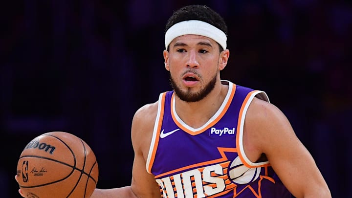 Dec 1, 2025; Los Angeles, California, USA; Phoenix Suns guard Devin Booker (1) moves the ball up court against the Los Angeles Lakers during the first half at Crypto.com Arena. Mandatory Credit: Gary A. Vasquez-Imagn Images