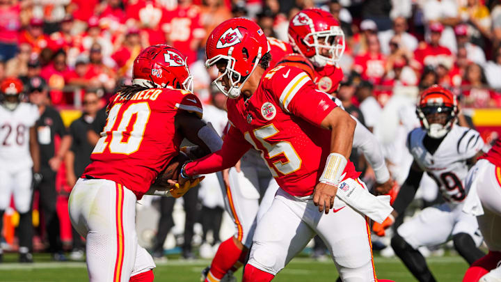 Sep 15, 2024; Kansas City, Missouri, USA; Kansas City Chiefs quarterback Patrick Mahomes (15) hands off to running back Isiah Pacheco (10) against the Cincinnati Bengals during the first half at GEHA Field at Arrowhead Stadium. Mandatory Credit: Denny Medley-Imagn Images