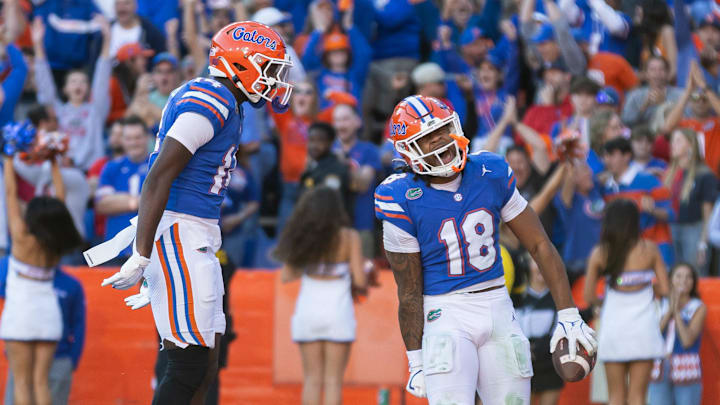 Nov 23, 2024; Gainesville, Florida, USA; Florida Gators defensive back Jordan Castell (14) celebrates after Bryce Thornton’s (18) interception in the fourth quarter against the Mississippi Rebels during the second half at Ben Hill Griffin Stadium. Mandatory Credit: Matt Pendleton-Imagn Images