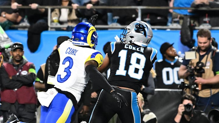 Jan 10, 2026; Charlotte, NC, USA; Carolina Panthers wide receiver Jalen Coker (18) makes a touchdown catch against Los Angeles Rams safety Kam Curl (3) in the second half during the NFC Wild Card Round game at Bank of America Stadium. Mandatory Credit: Bob Donnan-Imagn Images Jan 10, 2026; Charlotte, NC, USA; Carolina Panthers wide receiver Jalen Coker (18) makes a touchdown catch against Los Angeles Rams safety Kam Curl (3) in the second half during the NFC Wild Card Round game at Bank of America Stadium. Mandatory Credit: Bob Donnan-Imagn Images