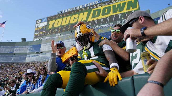 Green Bay Packers wide receiver Jayden Reed (11) celebrates with fans after scoring a touchdown against the Detroit Lions.