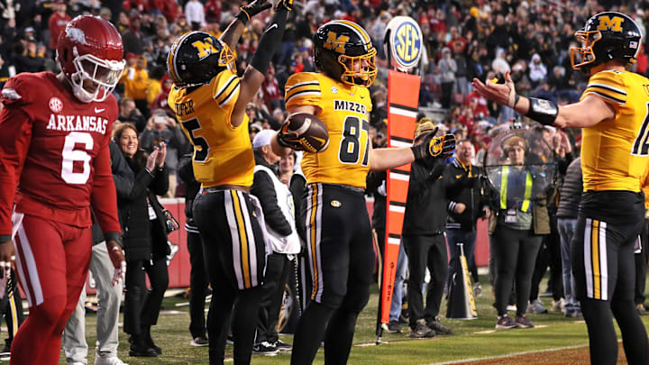 Missouri Tigers tight end Brett Norfleet (87) celebrates with quarterback Brady Cook (12) after scoring a touchdown in the third quarter against the Arkansas Razorbacks at Razorback Stadium.