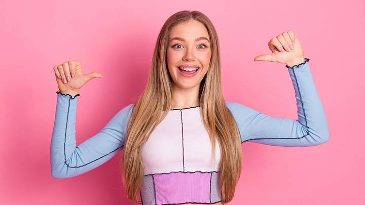 Girl posing with a happy expression and bright outfit