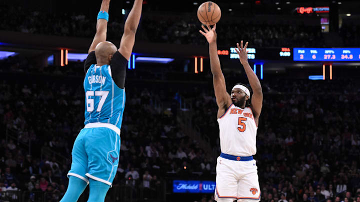 Oct 15, 2024; New York, New York, USA; New York Knicks forward Precious Achiuwa (5) shoots the ball while being defended by Charlotte Hornets forward Taj Gibson (67) during the first half at Madison Square Garden. Mandatory Credit: John Jones-Imagn Images