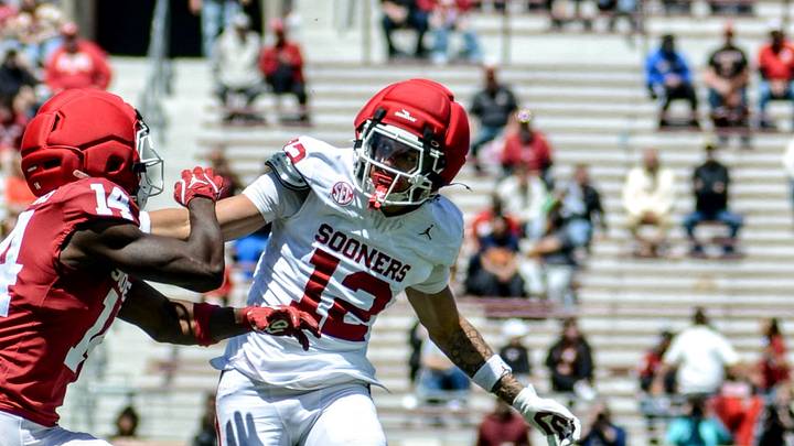 Oklahoma defensive back Derrick Johnson II defends a pass intended for wide receiver Elijah Thomas in the spring game.