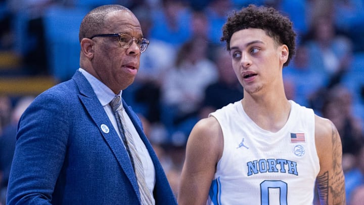 Nov 18, 2025; Chapel Hill, North Carolina, USA; North Carolina Tar Heels head coach Hubert Davis talks to guard Kyan Evans (0) during the second half against the Navy Midshipmen at Dean E. Smith Center. Mandatory Credit: Scott Kinser-Imagn Images